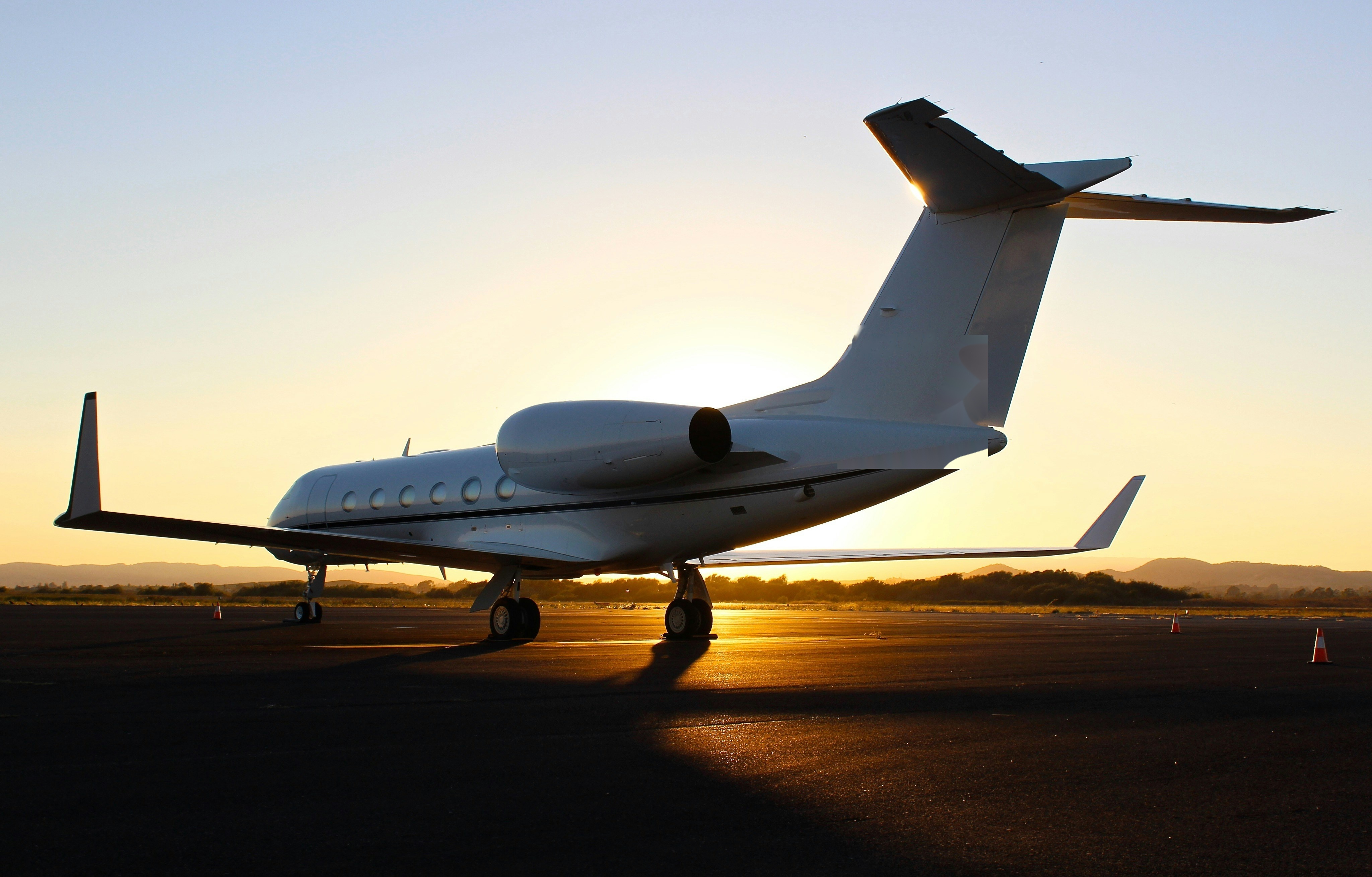 Private jet on tarmac at sunset